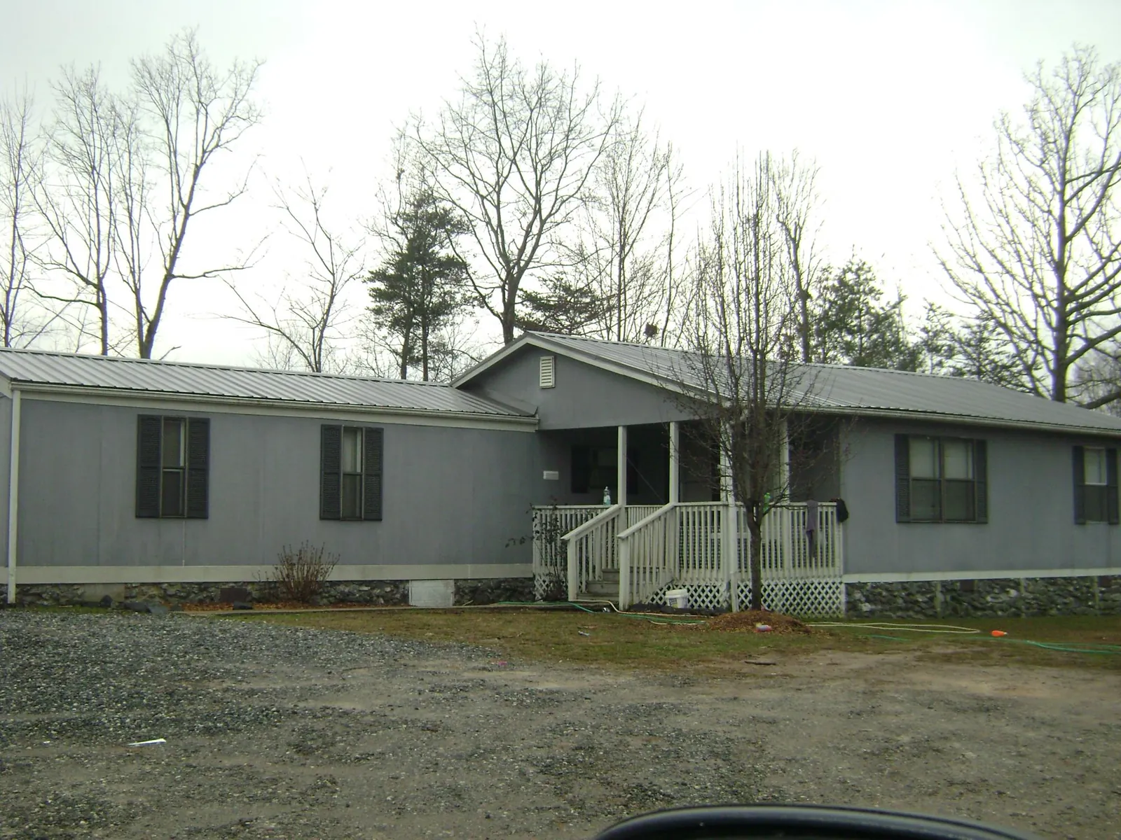 Metal roof over a manufactured home with a covered front porch in Glen Mills